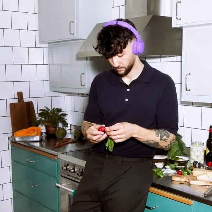 Man in kitchen with headphones